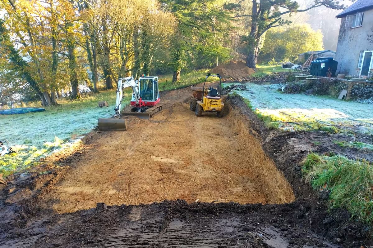 Excavator and dumper stripping and levelling a site